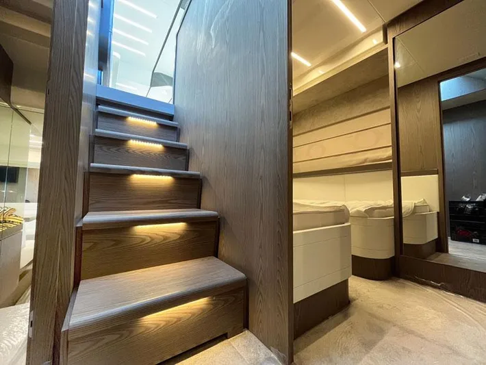  Yacht Photos Pics Luxurious interior of 2018 Ferretti Yachts 550 with illuminated wooden stairs and modern design.