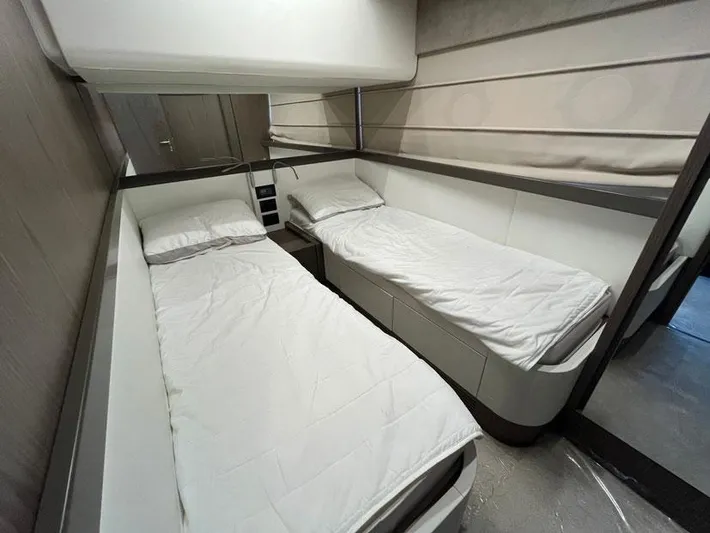  Yacht Photos Pics Twin cabin interior of 2018 Ferretti Yachts 550 with modern design and white bedding.