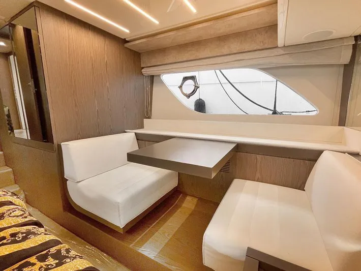  Yacht Photos Pics Interior of 2018 Ferretti Yachts 550 with modern seating and table arrangement.