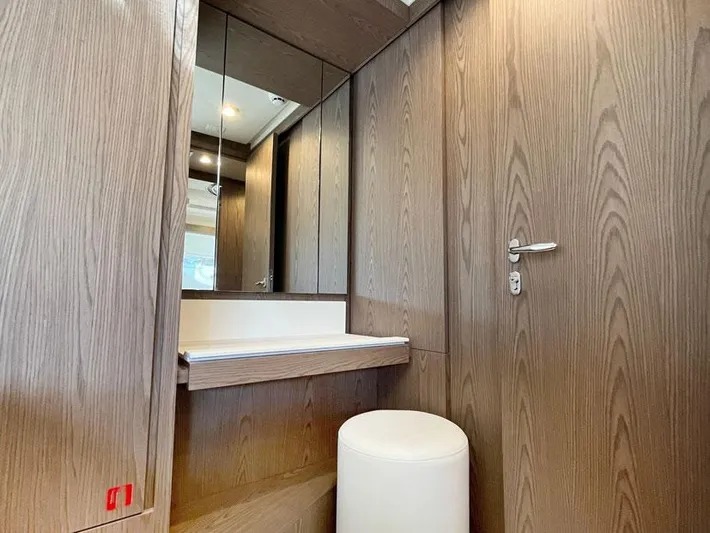  Yacht Photos Pics Luxurious wooden interior of 2018 Ferretti Yachts 550 with mirror and seating.