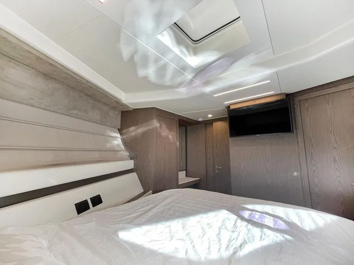  Yacht Photos Pics Luxurious bedroom interior of 2018 Ferretti Yachts 550 with modern design and skylight.