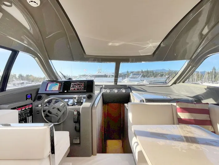  Yacht Photos Pics Interior of 2018 Ferretti Yachts 550, featuring modern helm and luxurious seating.