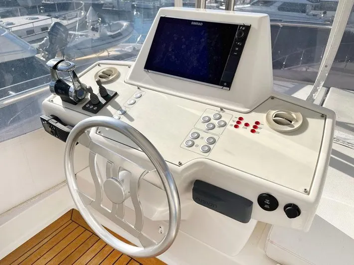 Yacht Photos Pics Cockpit of 2018 Ferretti Yachts 550 with steering wheel and navigation controls.