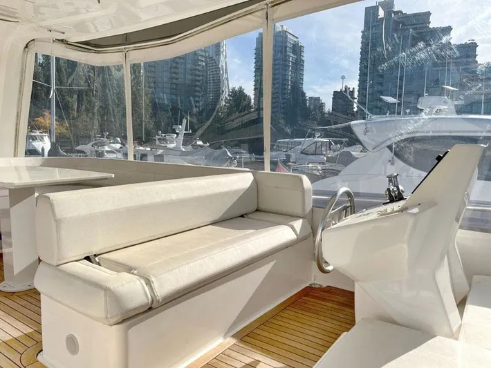  Yacht Photos Pics 2018 Ferretti Yachts 550 interior with white seating and helm, docked in marina.