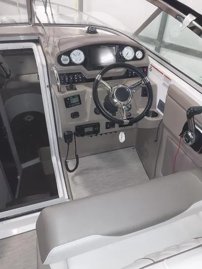 Northern Exposure II Yacht Photos Pics 2018 Regal 28 Express boat cockpit with steering wheel and control panel.