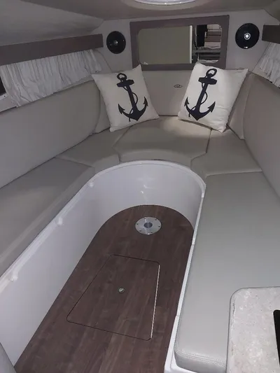 Northern Exposure II Yacht Photos Pics 2018 Regal 28 Express cabin interior with anchor-themed pillows and seating area.