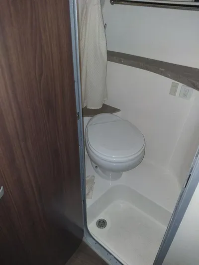 Northern Exposure II Yacht Photos Pics 2018 Regal 28 Express boat bathroom with toilet and shower area.