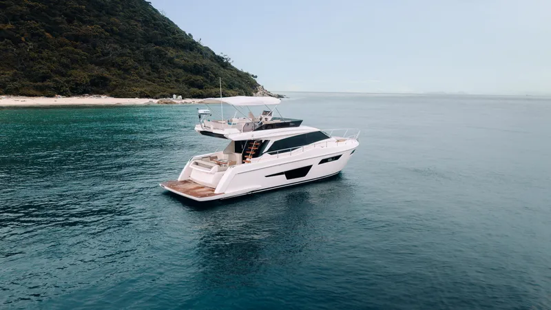  Yacht Photos Pics 2022 Ferretti Yachts 500 cruising near a lush coastline.