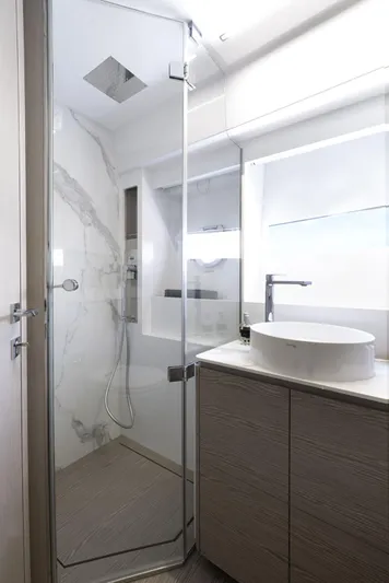  Yacht Photos Pics Modern bathroom in 2022 Ferretti Yachts 500 with glass shower and sleek fixtures.