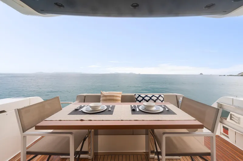  Yacht Photos Pics Outdoor dining area on 2022 Ferretti Yachts 500, overlooking serene ocean view.