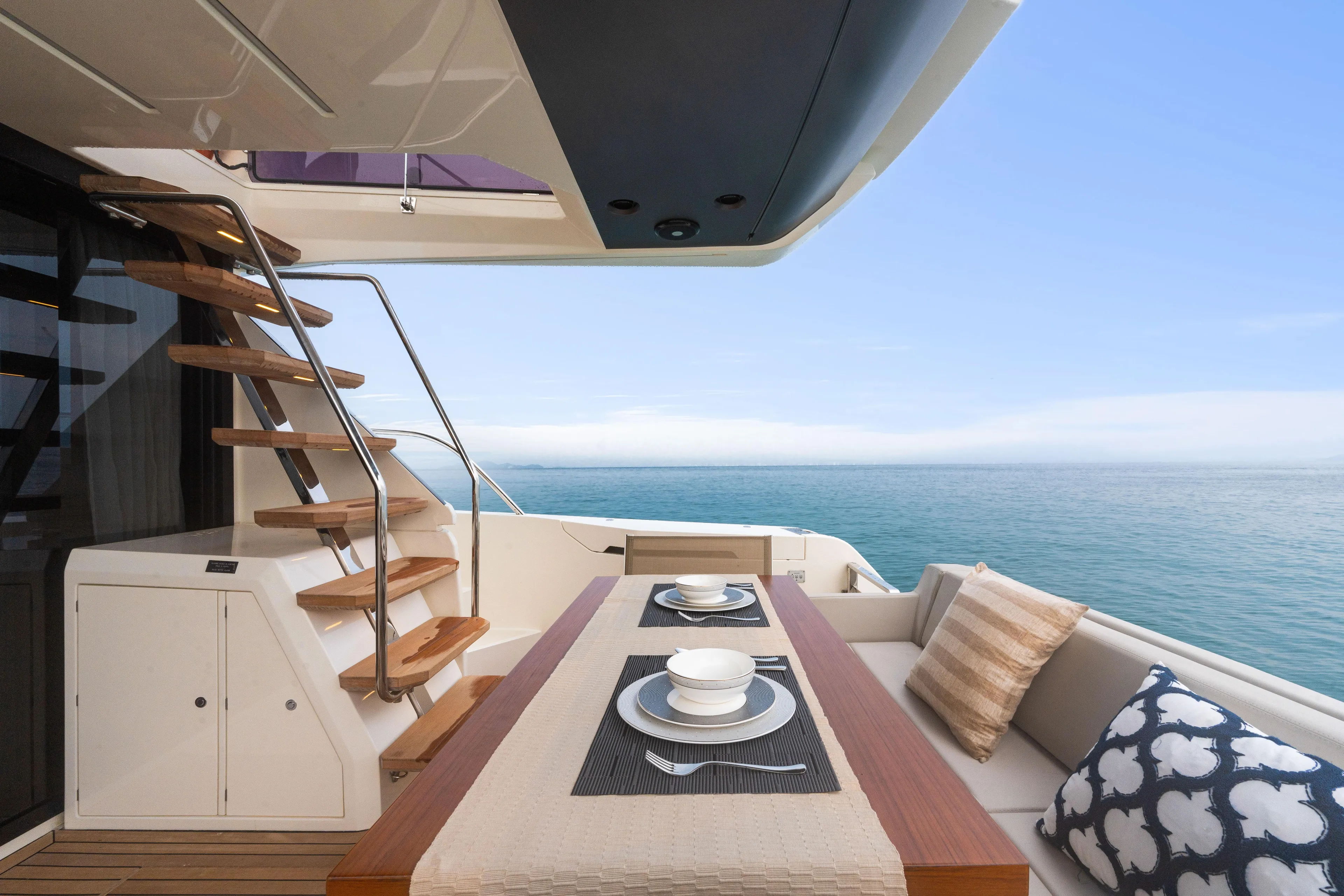  Yacht Photos Pics Luxurious 2022 Ferretti Yachts 500 deck with dining area overlooking the ocean.