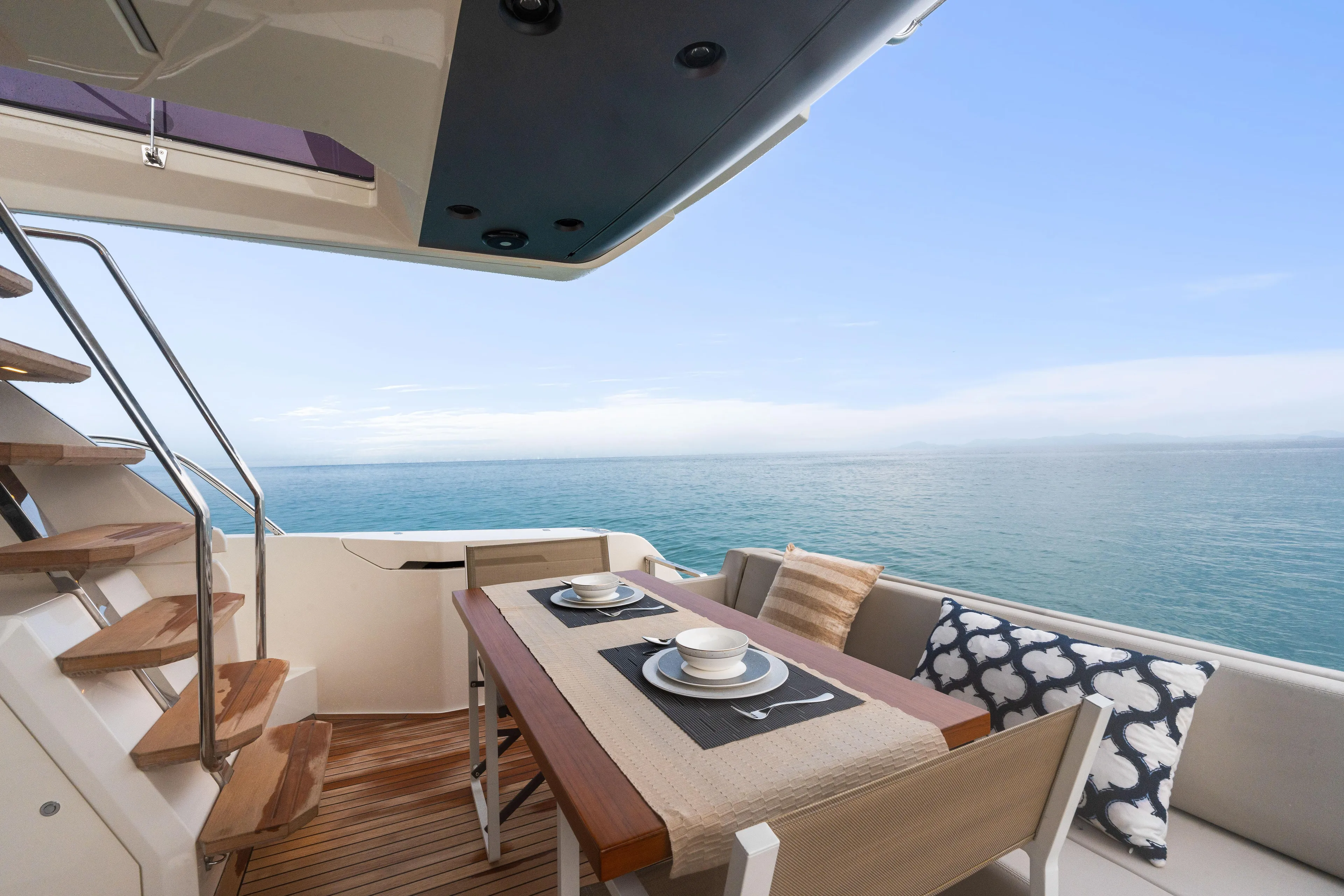  Yacht Photos Pics 2022 Ferretti Yachts 500 deck with dining area overlooking the ocean.