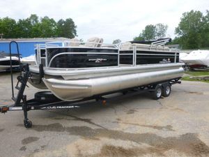 2024 Sun Tracker Sportfish 24 XP3 pontoon boat on trailer, parked outdoors.