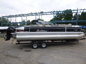 2024 Sun Tracker Sportfish 24 XP3 pontoon boat on trailer in outdoor setting.