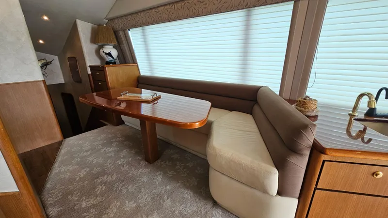  Yacht Photos Pics Interior of 2000 Ocean Yachts 70 Super Sport with elegant seating and wooden table.