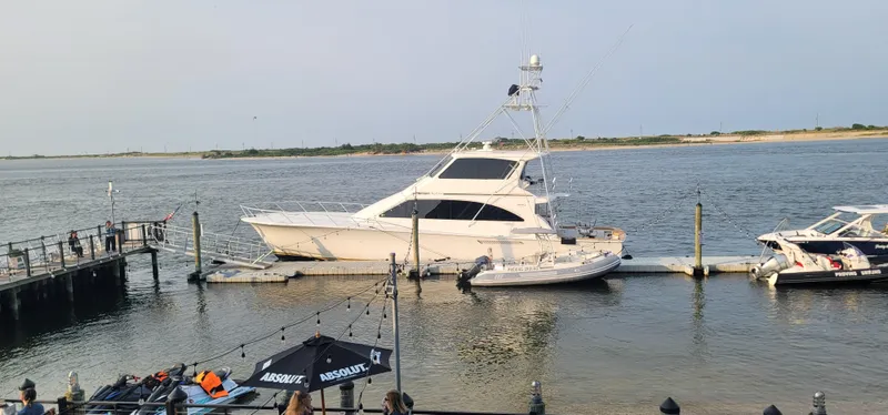  Yacht Photos Pics A 2000 Ocean Yachts 70 Super Sport docked at a marina on a calm day.