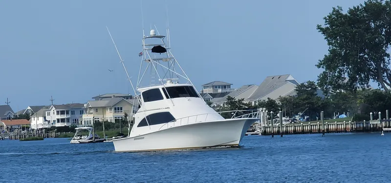  Yacht Photos Pics Ocean Yachts 70 Super Sport 2000 cruising near waterfront homes and docks.