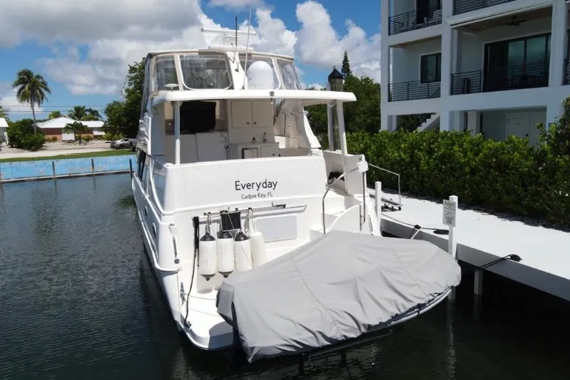 Everyday Yacht Photos Pics 2003 Silverton 453 Motor Yacht docked near modern building, sunny day.