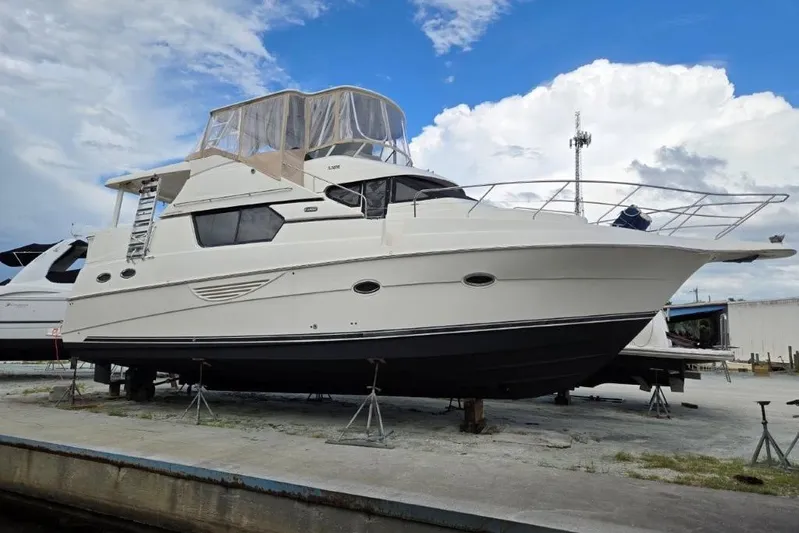 Everyday Yacht Photos Pics 2003 Silverton 453 Motor Yacht on dry dock under a partly cloudy sky.