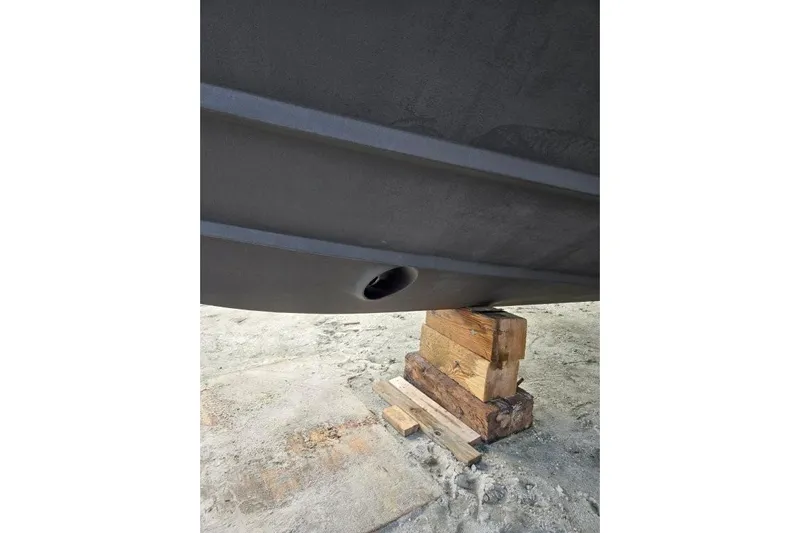 Everyday Yacht Photos Pics 2003 Silverton 453 Motor Yacht hull on wooden blocks, showcasing underside details.