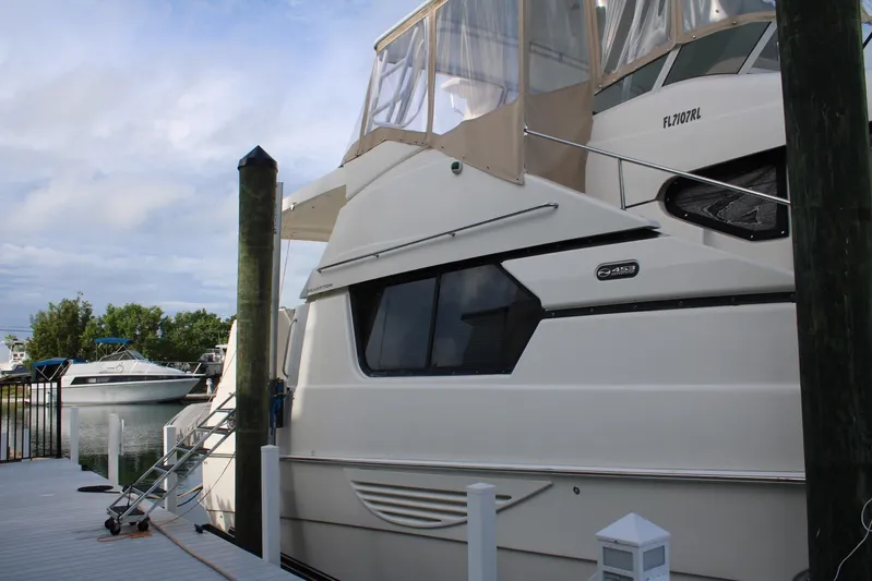 Everyday Yacht Photos Pics 2003 Silverton 453 Motor Yacht docked at marina under cloudy sky.