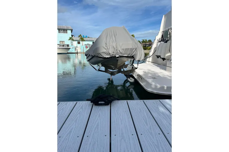 Everyday Yacht Photos Pics 2003 Silverton 453 Motor Yacht docked, covered, reflecting on calm water.