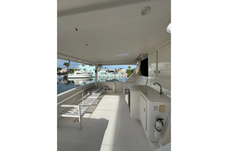 Everyday Yacht Photos Pics 2003 Silverton 453 Motor Yacht interior with kitchenette and seating, docked by waterfront homes.