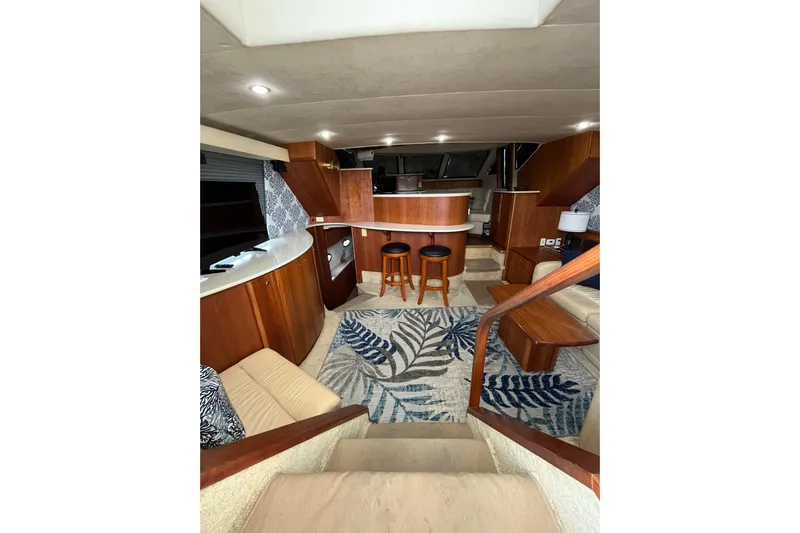 Everyday Yacht Photos Pics Interior of 2003 Silverton 453 Motor Yacht with elegant wood finishes and cozy seating area.