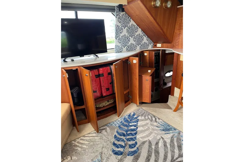 Everyday Yacht Photos Pics Interior of 2003 Silverton 453 Motor Yacht with open cabinets and TV.