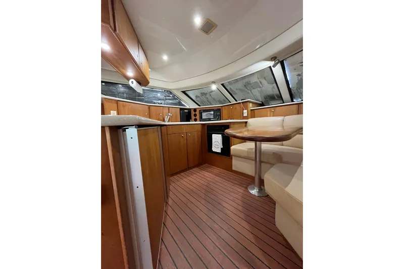 Everyday Yacht Photos Pics Interior of 2003 Silverton 453 Motor Yacht with wood cabinetry and seating area.
