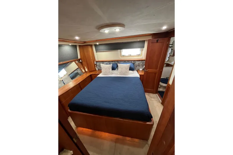 Everyday Yacht Photos Pics Luxurious bedroom interior of 2003 Silverton 453 Motor Yacht with elegant wood finishes.