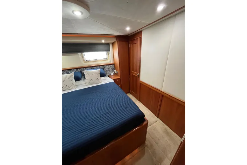 Everyday Yacht Photos Pics Luxurious bedroom interior of 2003 Silverton 453 Motor Yacht with elegant wood finishes.