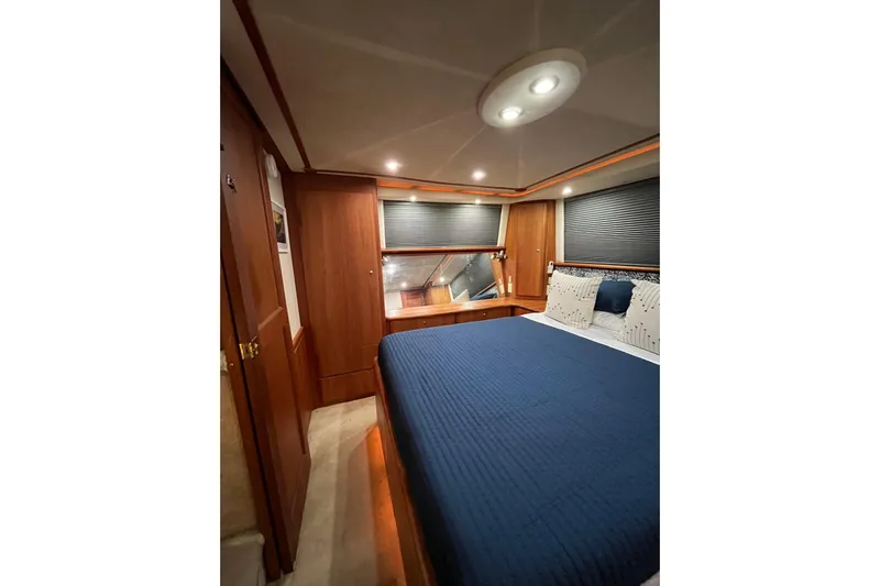 Everyday Yacht Photos Pics Luxurious bedroom interior of 2003 Silverton 453 Motor Yacht with blue bedding.