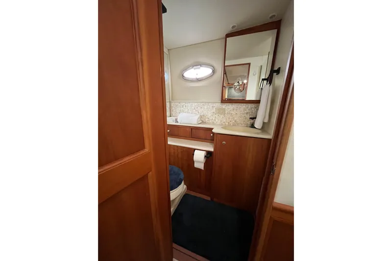 Everyday Yacht Photos Pics Luxurious bathroom in 2003 Silverton 453 Motor Yacht with wood cabinetry and modern fixtures.