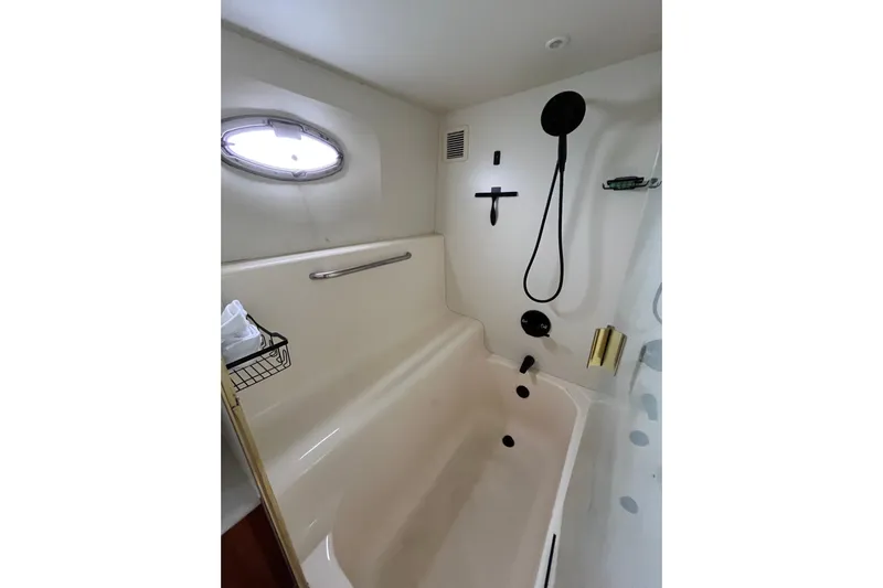 Everyday Yacht Photos Pics 2003 Silverton 453 Motor Yacht bathroom with shower, porthole, and modern fixtures.