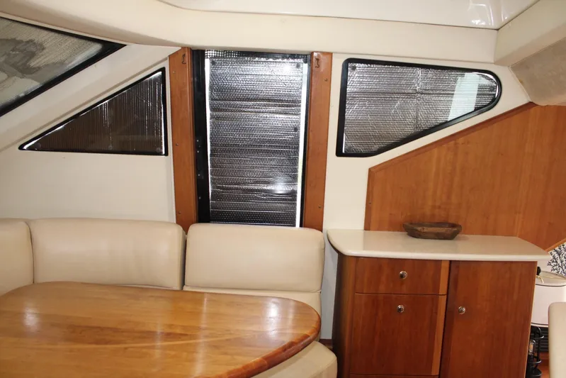 Everyday Yacht Photos Pics Interior of 2003 Silverton 453 Motor Yacht with wood cabinetry and cushioned seating.