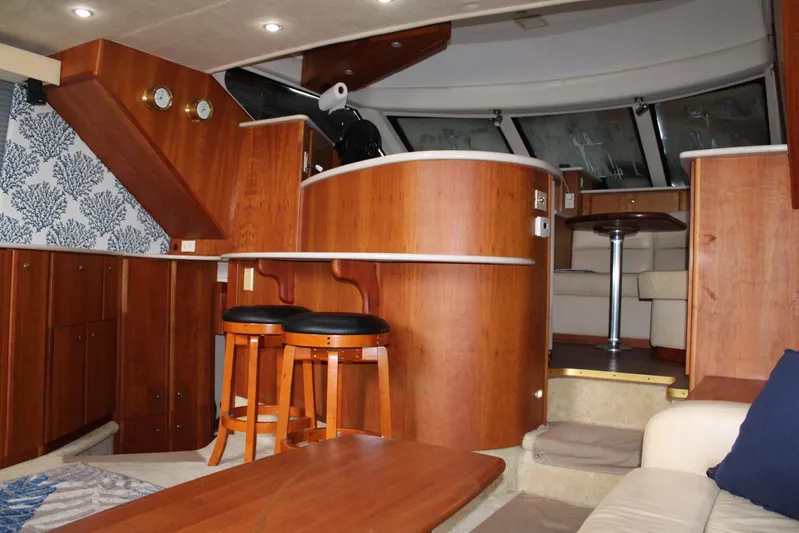 Everyday Yacht Photos Pics Luxurious interior of 2003 Silverton 453 Motor Yacht with wood finishes and seating area.