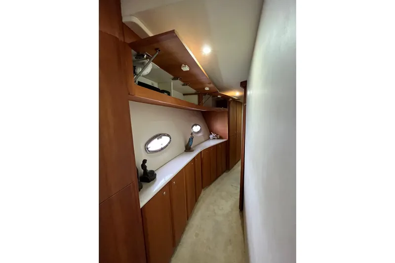 Everyday Yacht Photos Pics Interior hallway of 2003 Silverton 453 Motor Yacht with wooden cabinets and porthole windows.