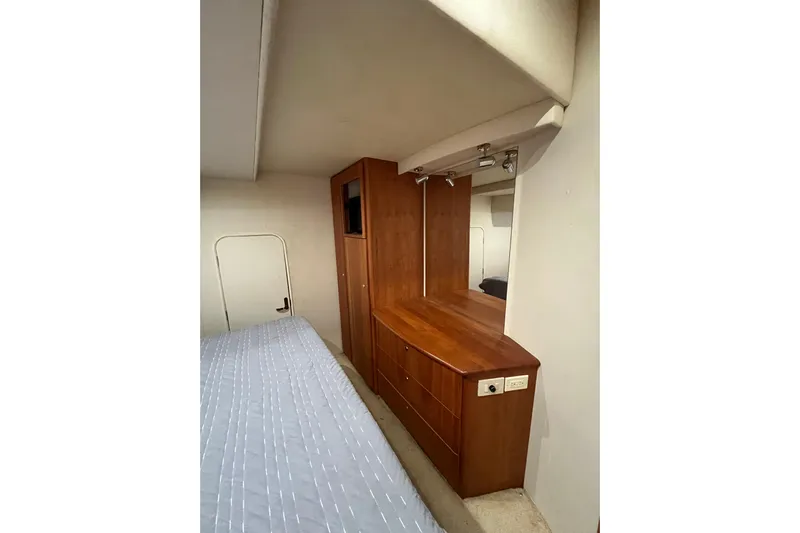 Everyday Yacht Photos Pics Interior of 2003 Silverton 453 Motor Yacht with wooden cabinetry and bed.