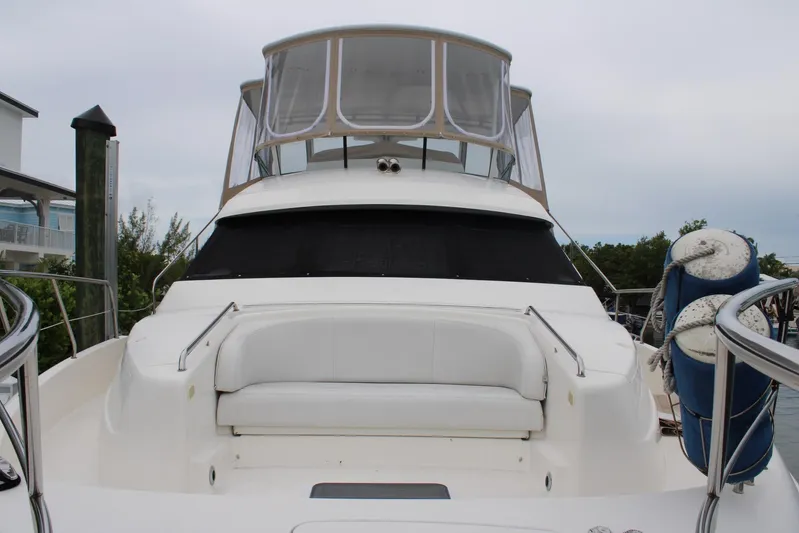 Everyday Yacht Photos Pics 2003 Silverton 453 Motor Yacht with spacious deck and seating, docked at marina.