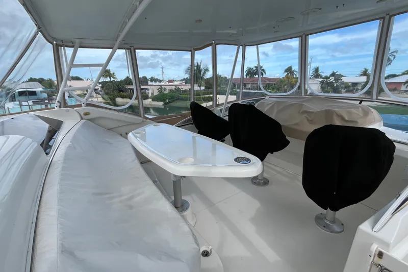 Everyday Yacht Photos Pics 2003 Silverton 453 Motor Yacht interior with seating and table, surrounded by windows.