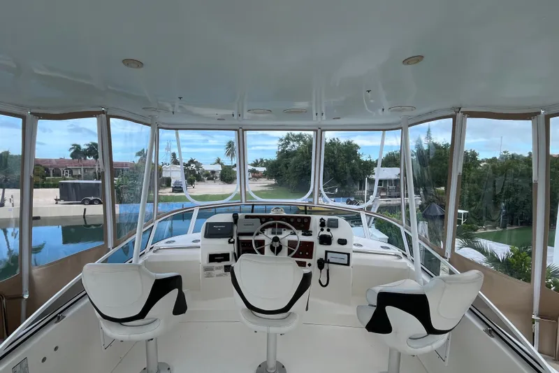 Everyday Yacht Photos Pics 2003 Silverton 453 Motor Yacht helm with panoramic view and modern controls.