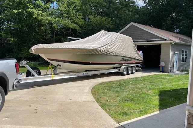  Yacht Photos Pics 2023 Renegade 38 GTS Open boat on trailer, covered, near garage.