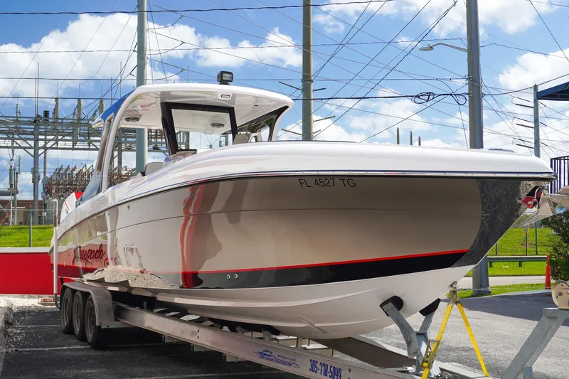  Yacht Photos Pics 2023 Renegade 38 GTS Open boat on trailer, sleek design, parked outdoors.