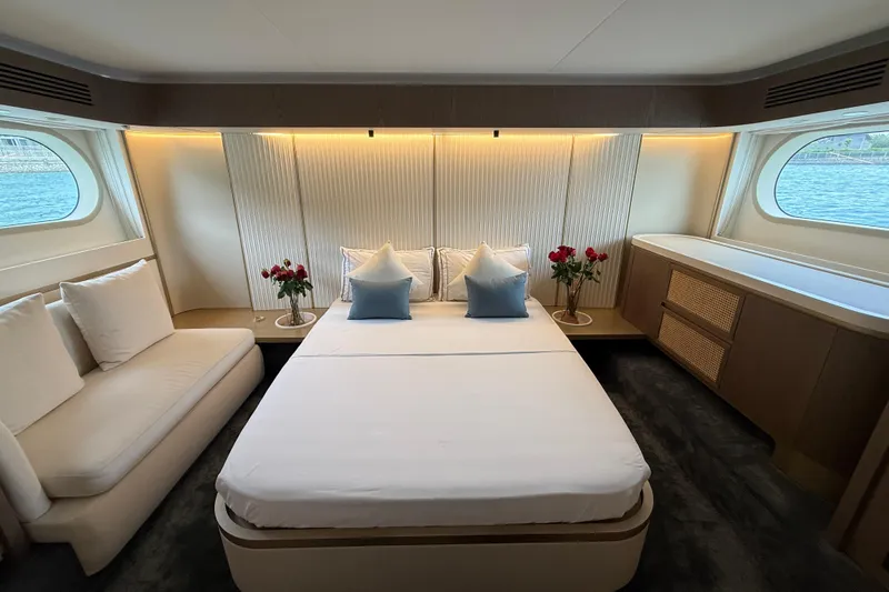  Yacht Photos Pics Luxurious bedroom interior of 2024 Azimut Magellano 60 yacht with elegant decor and large windows.