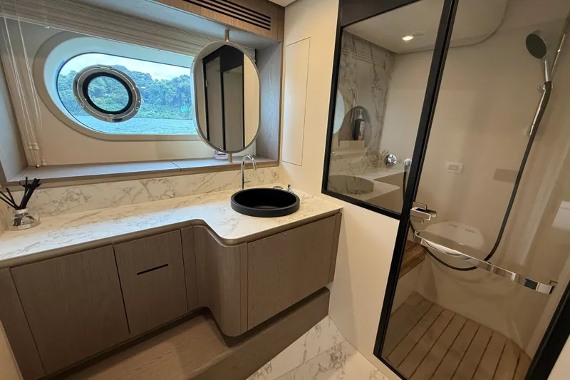  Yacht Photos Pics Luxurious bathroom in 2024 Azimut Magellano 60 yacht with modern fixtures and ocean view.
