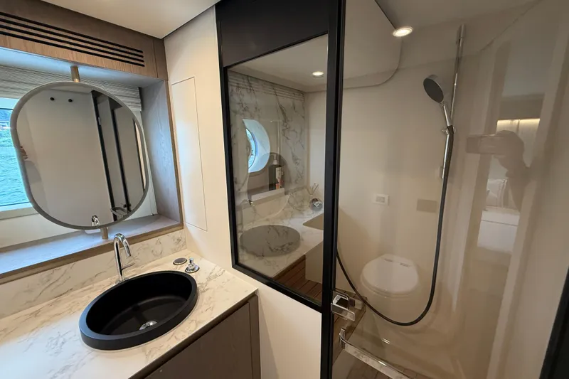  Yacht Photos Pics Luxurious bathroom in 2024 Azimut Magellano 60 yacht with modern fixtures and elegant design.