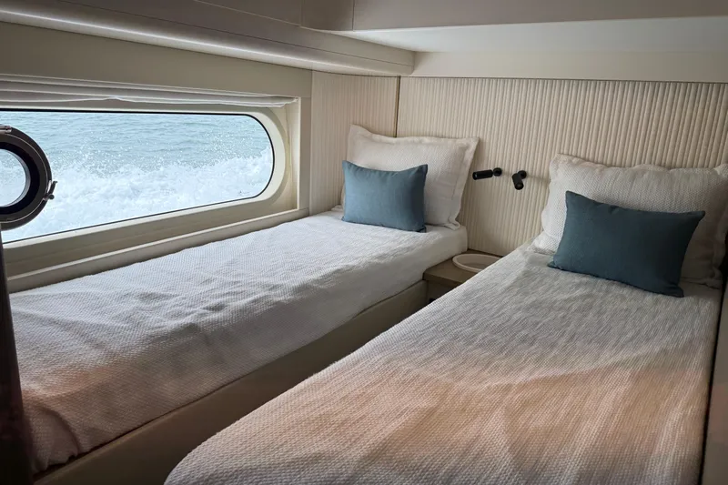  Yacht Photos Pics Twin beds in the 2024 Azimut Magellano 60 yacht cabin with ocean view.
