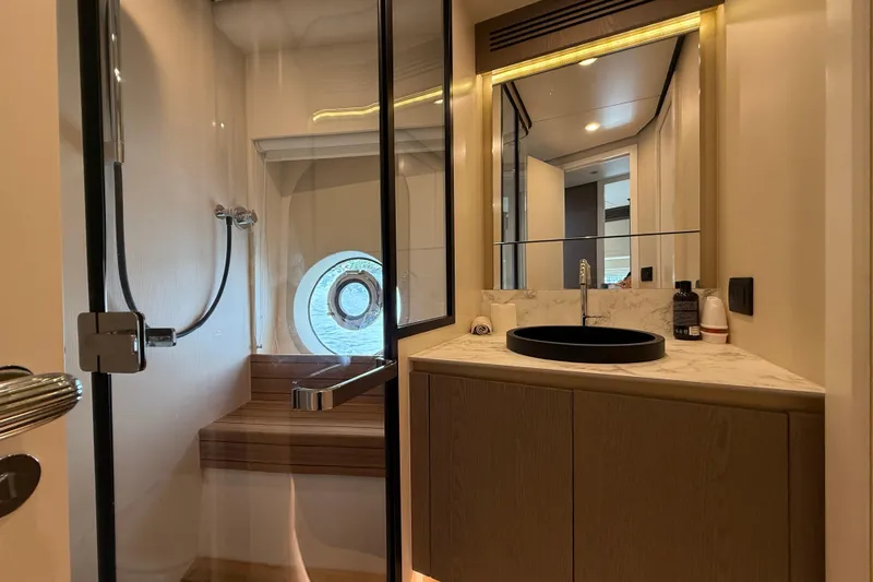  Yacht Photos Pics Luxurious bathroom interior of 2024 Azimut Magellano 60 yacht with modern fixtures.