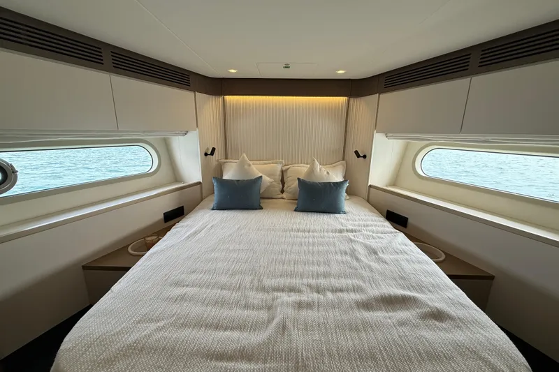  Yacht Photos Pics Luxurious bedroom interior of 2024 Azimut Magellano 60 yacht with ocean view.